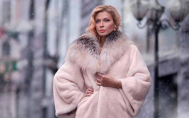 A girl wearing a fur coat